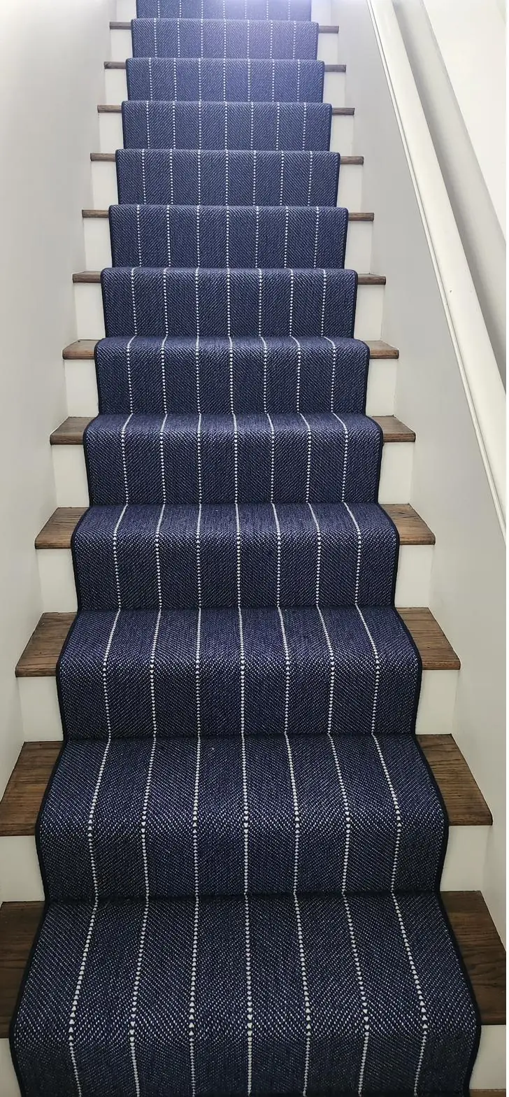 Navy pinstripe stair runner on oak treads — a QFI install