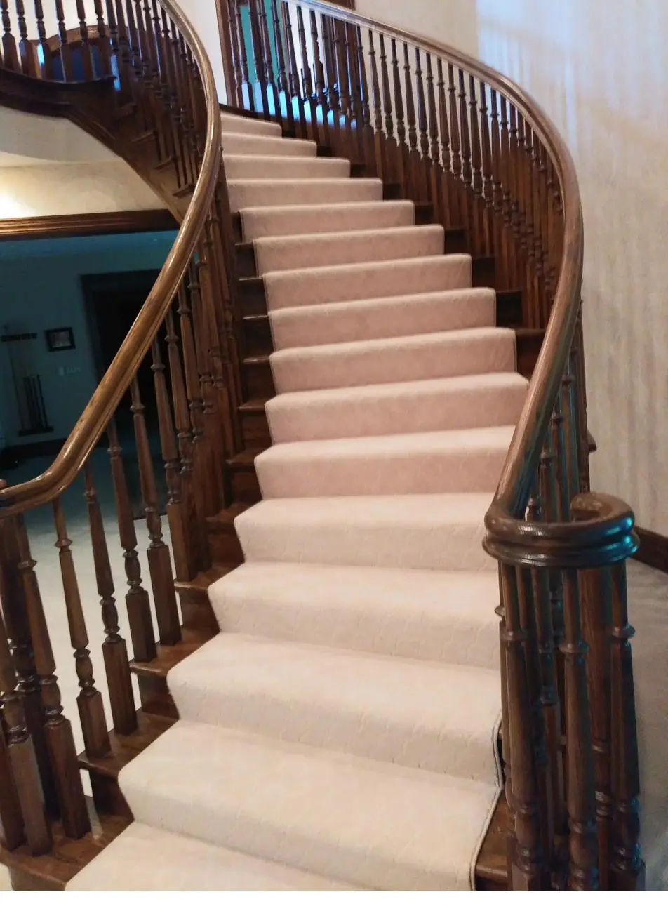 Cream carpet on a grand curved staircase — a QFI install